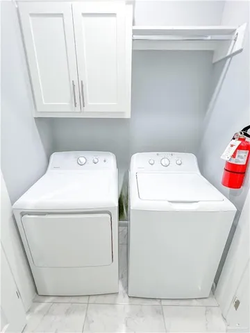 an empty room with windows and ceiling fan