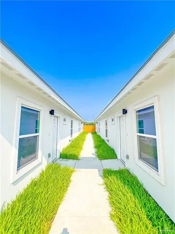 a large kitchen with kitchen island a counter space a sink cabinets and stainless steel appliances