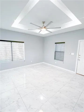 a large white kitchen with kitchen island a sink a stove a dining table and chairs