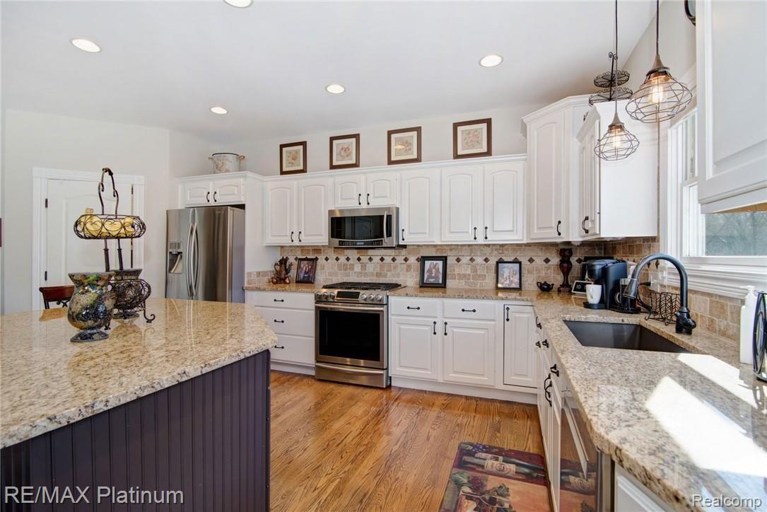 629 Brighton Lake Road Brighton, MI 48116 - Photo 2 of 45 Gorgeous custom kitchen with granite counters and stainless steel appliances - large walk-in pantry