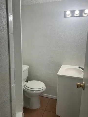a bathroom with a toilet and a mirror