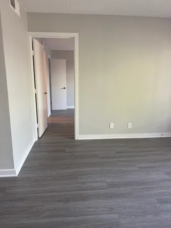 a view of a room with wooden floor