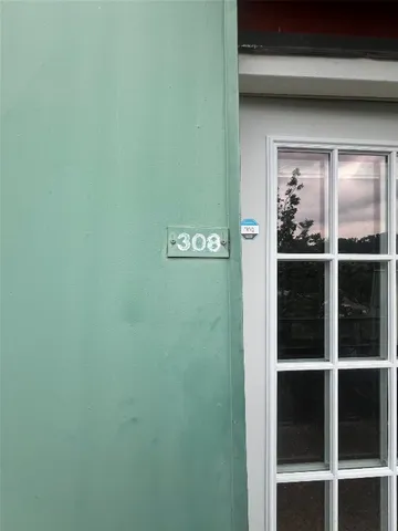 an empty room with a ceiling fan and windows
