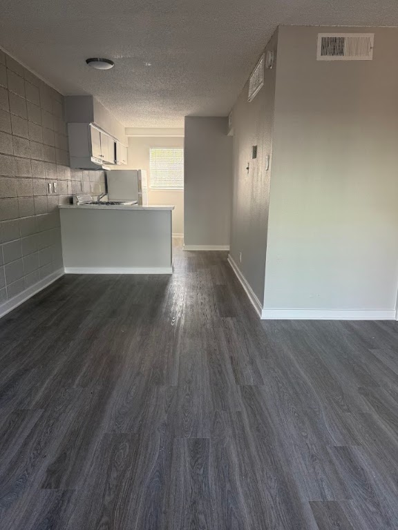 311 East 31st Street, Unit 202 Austin, TX 78705 - Photo 2 of 24 a view of a kitchen with wooden floor and a sink
