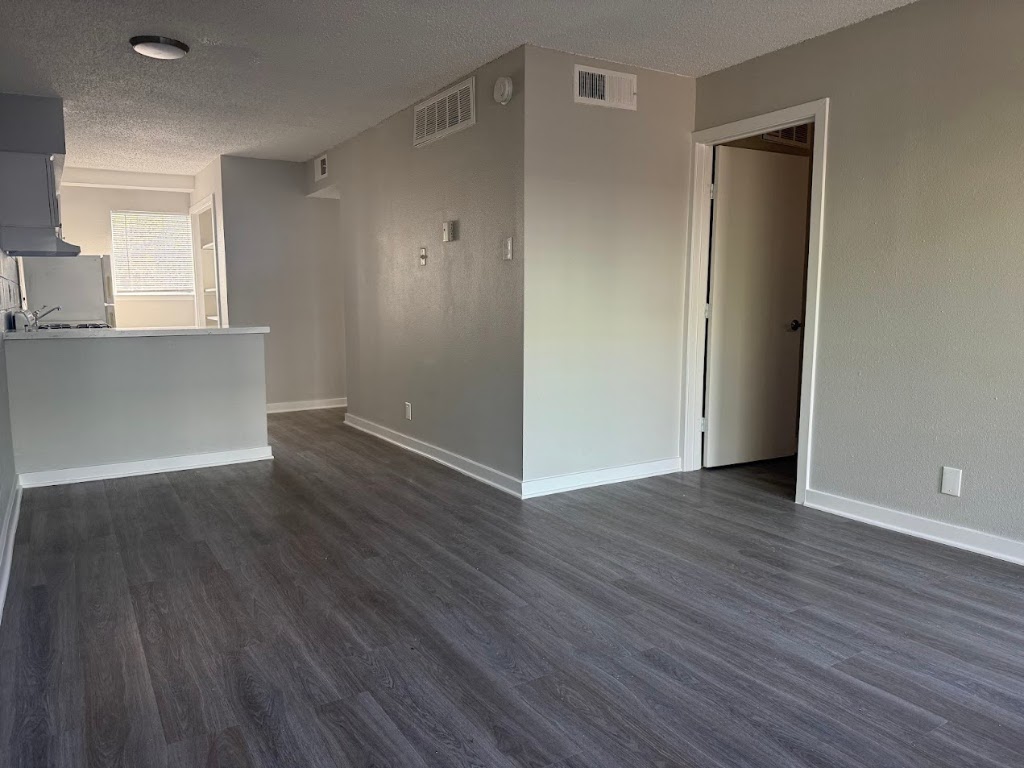 311 East 31st Street, Unit 202 Austin, TX 78705 - Photo 3 of 24 an empty room with wooden floor and windows