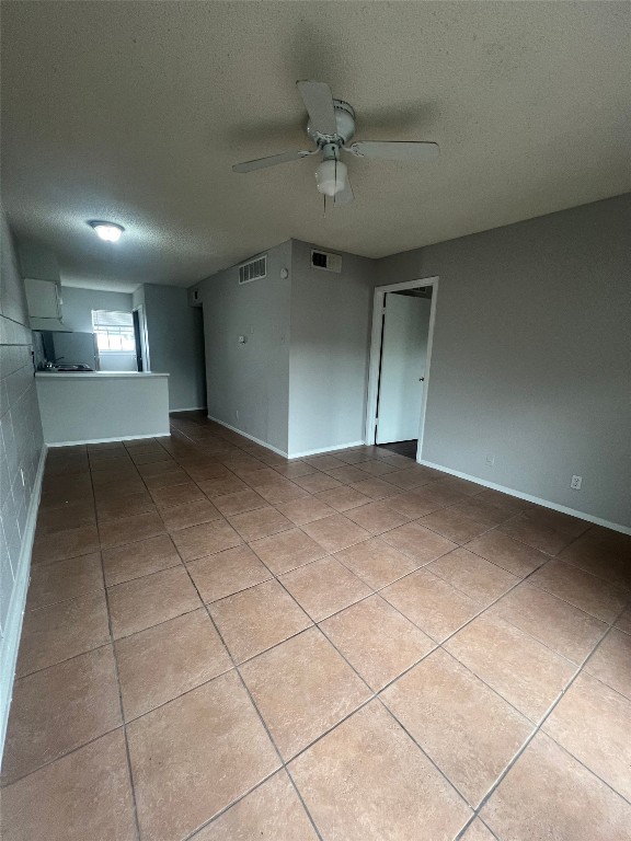311 East 31st Street, Unit 308 Austin, TX 78705 - Photo 3 of 26 an empty room with a ceiling fan and windows