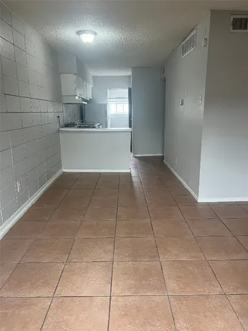 a view of a livingroom with a tiles and a window