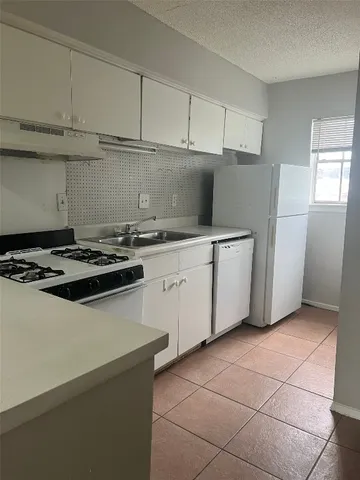 a kitchen with a cabinets and refrigerator