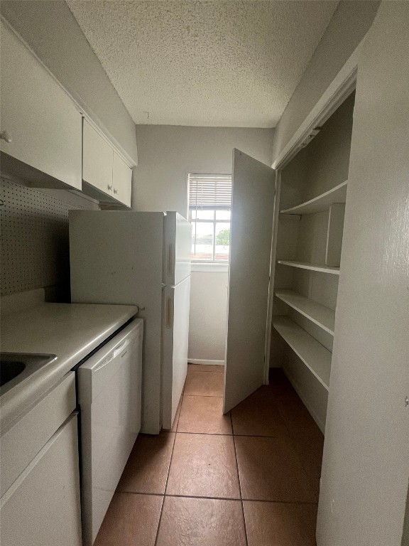 311 East 31st Street, Unit 308 Austin, TX 78705 - Photo 7 of 26 a kitchen with a cabinets and refrigerator