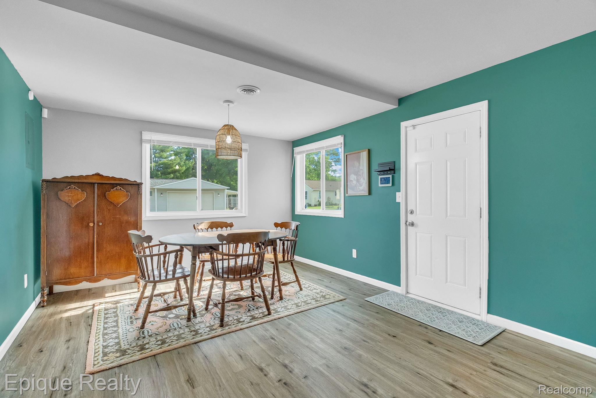 2182 North Center Road Burton, MI 48509 - Photo 16 of 34 Versatile room featuring wood-finish flooring, a contemporary ceiling light fixture, and two windows providing exterior views