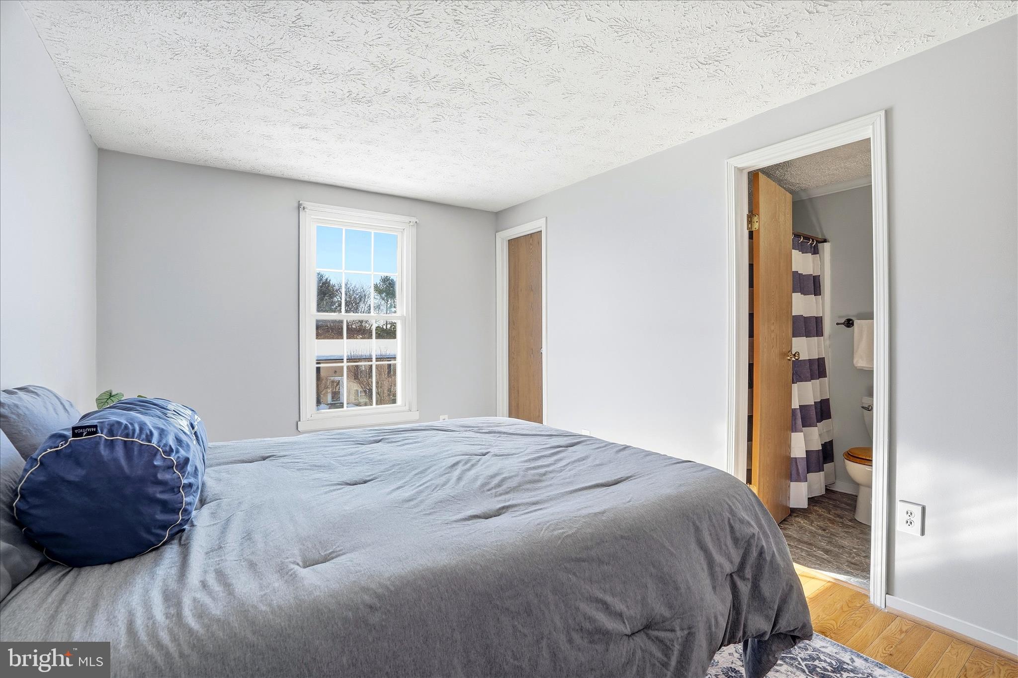 76 Hook Road Westminster, MD 21157 - Photo 17 of 38 a large bed sitting in a bedroom next to a window and dresser