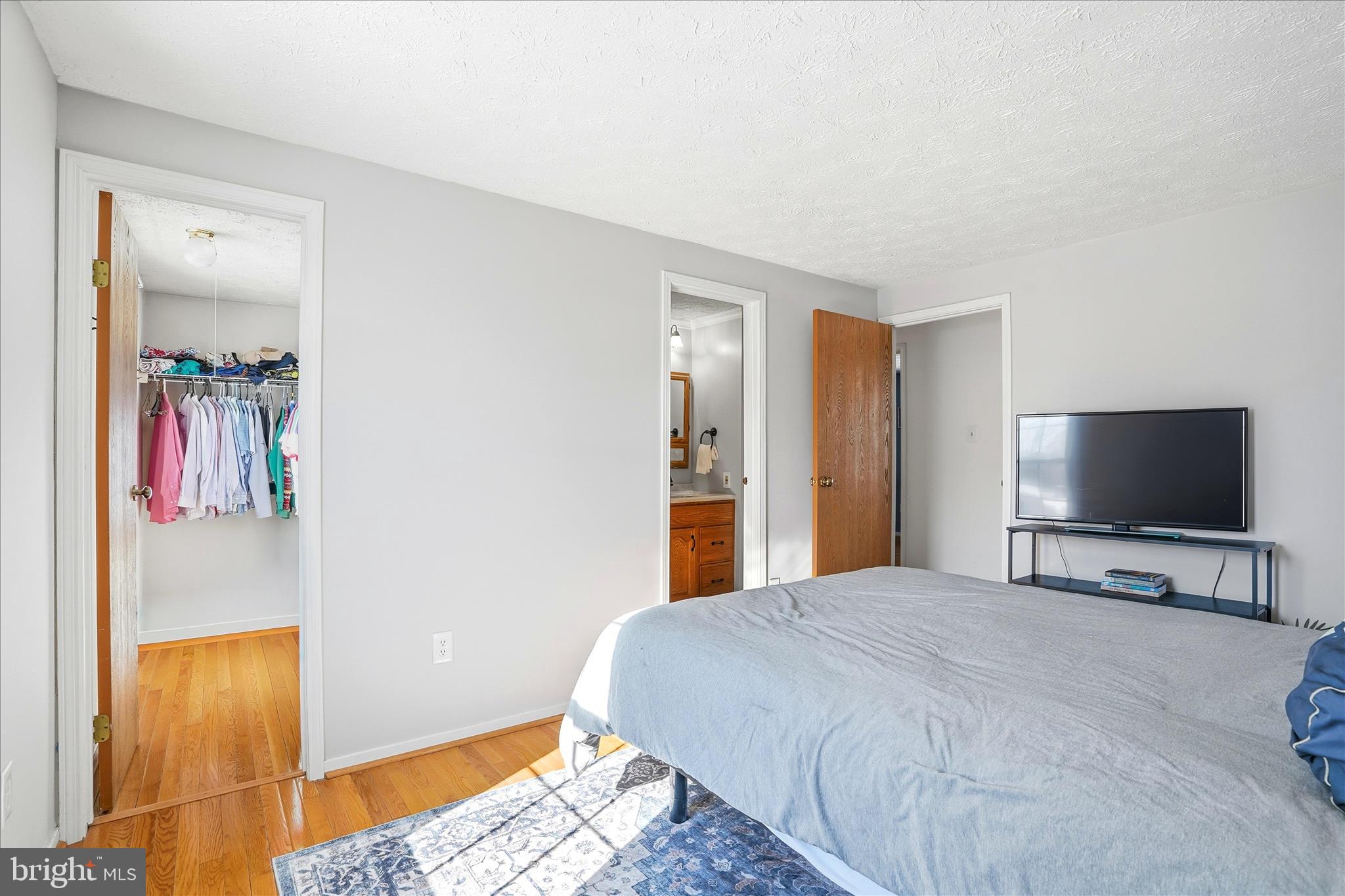 76 Hook Road Westminster, MD 21157 - Photo 18 of 38 a bedroom with a bed and a flat screen tv