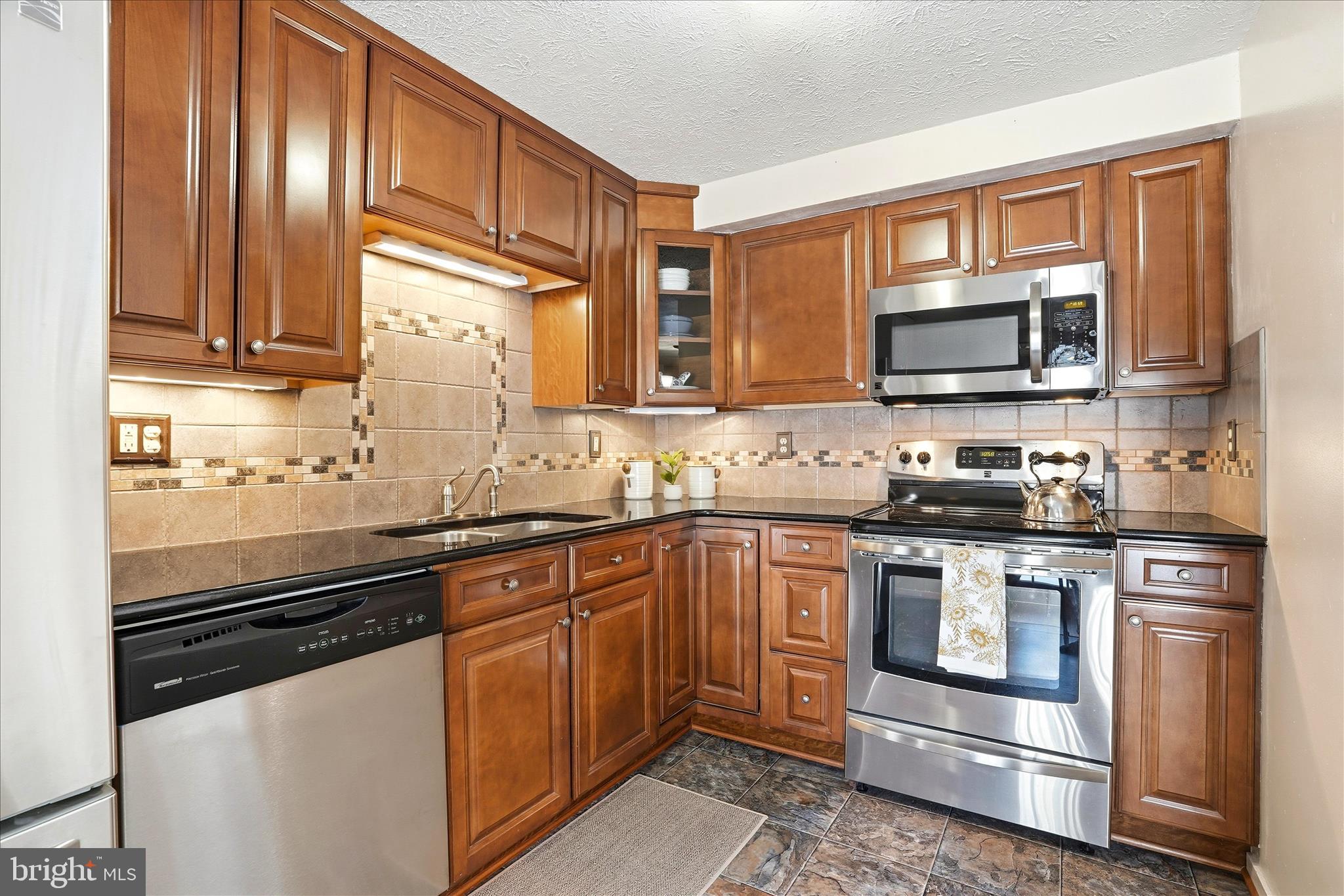76 Hook Road Westminster, MD 21157 - Photo 4 of 38 a kitchen with granite countertop a sink stove and microwave