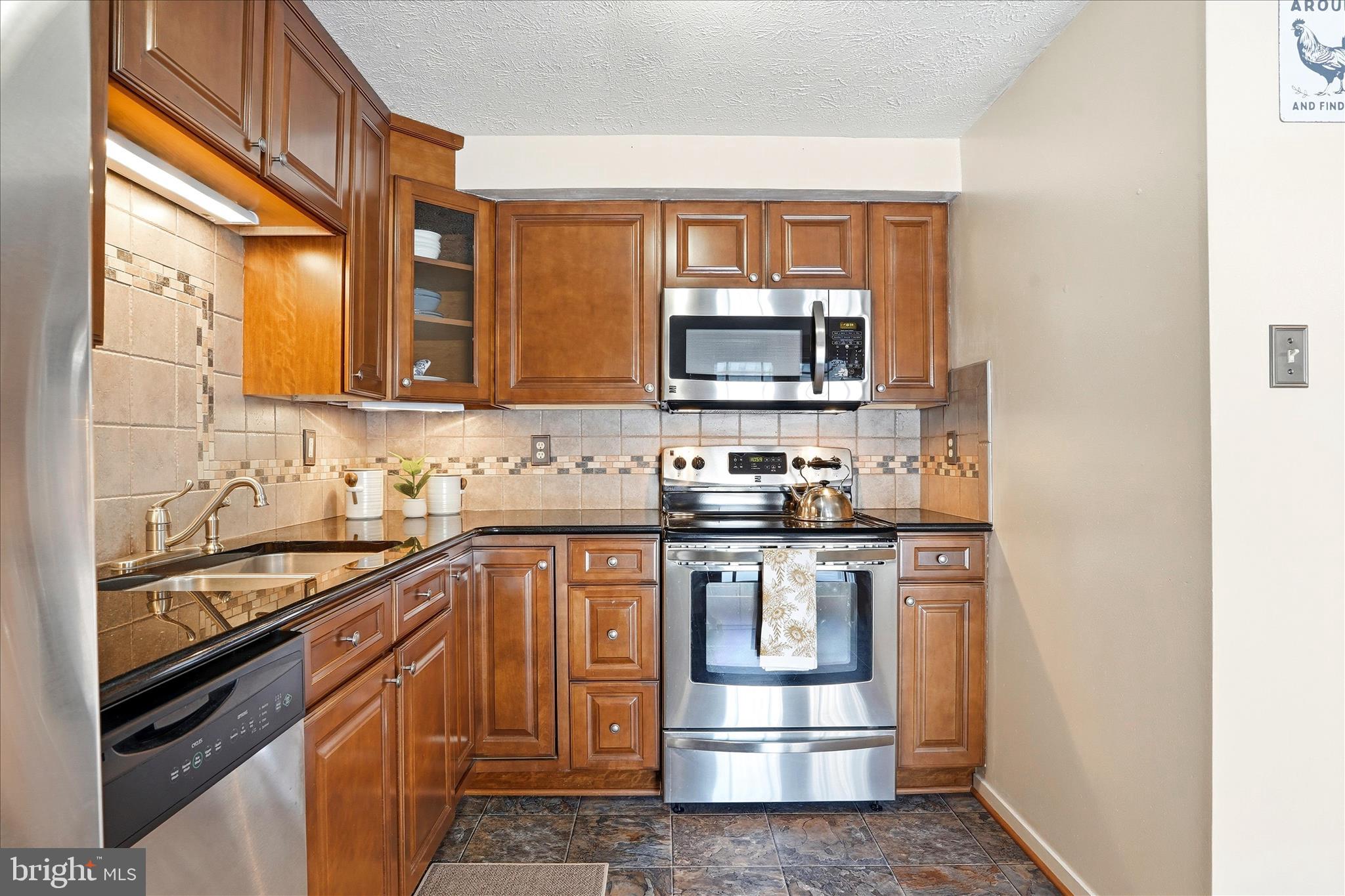 76 Hook Road Westminster, MD 21157 - Photo 5 of 38 a kitchen with stainless steel appliances a sink stove and microwave