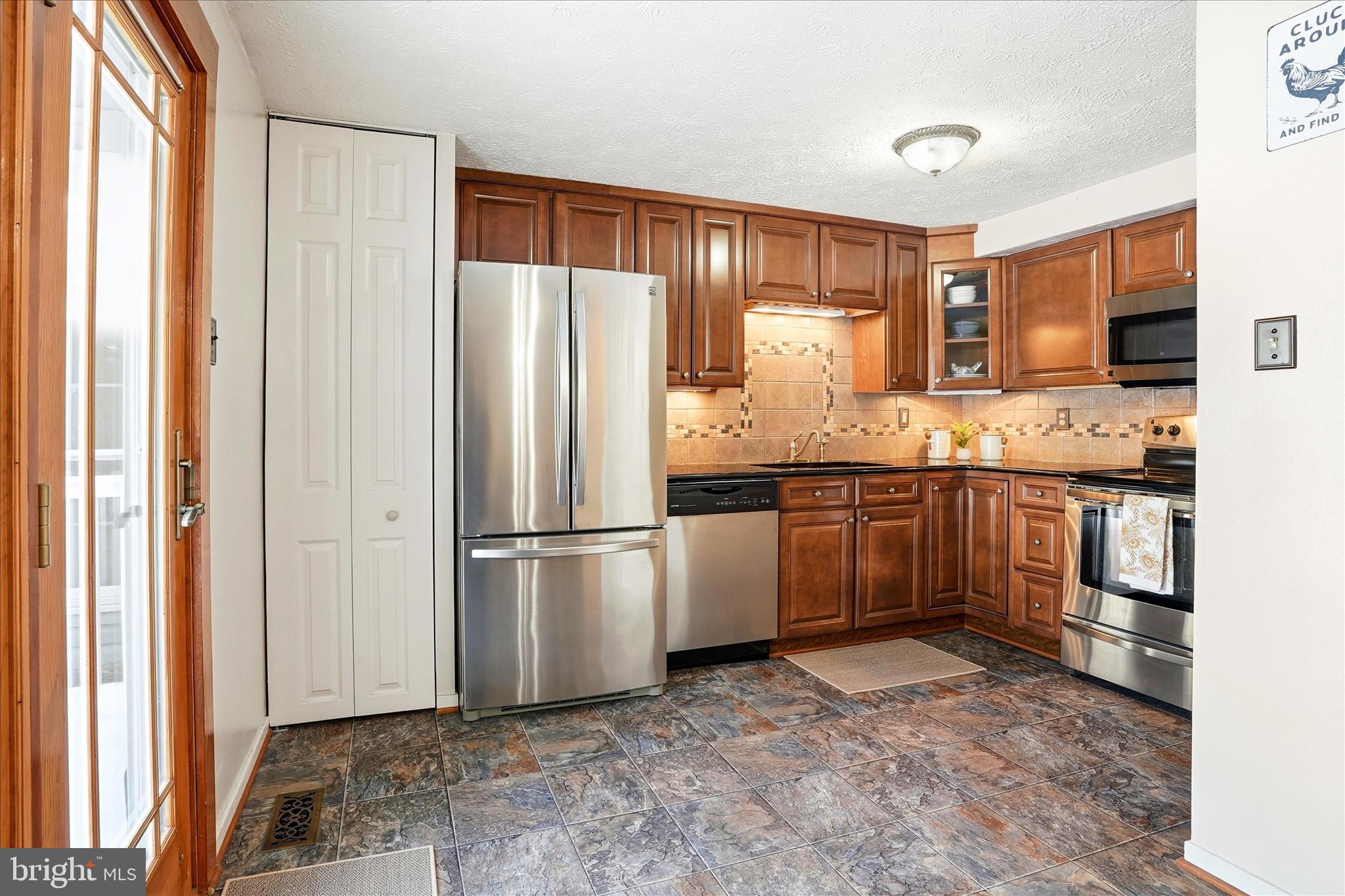 76 Hook Road Westminster, MD 21157 - Photo 7 of 38 a kitchen with a sink stove and refrigerator