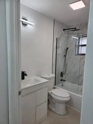 a bathroom with a toilet sink and shower