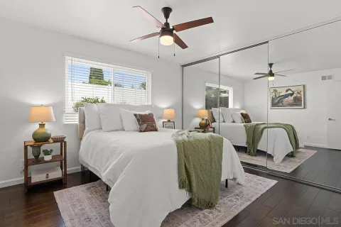 a bedroom with a bed and a painting on the wall