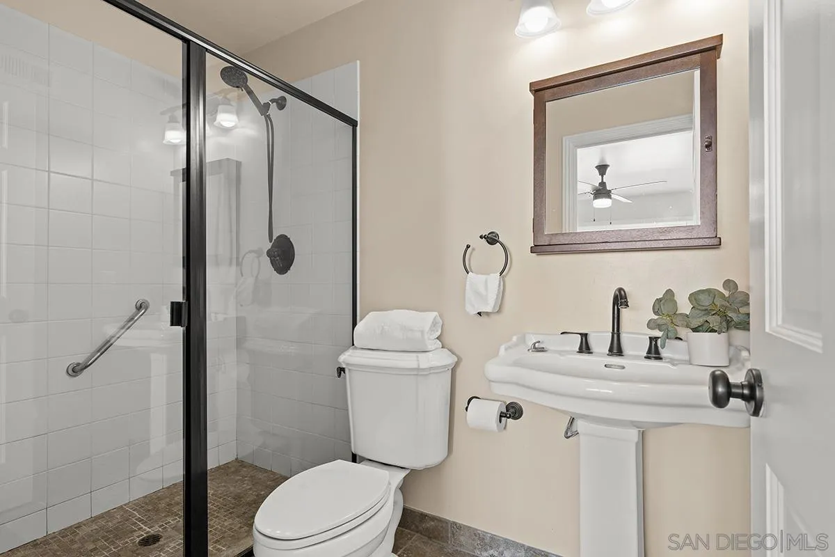 11394 Pegasus Avenue San Diego, CA 92126 - Photo 25 of 46 a bathroom with a toilet sink and mirror