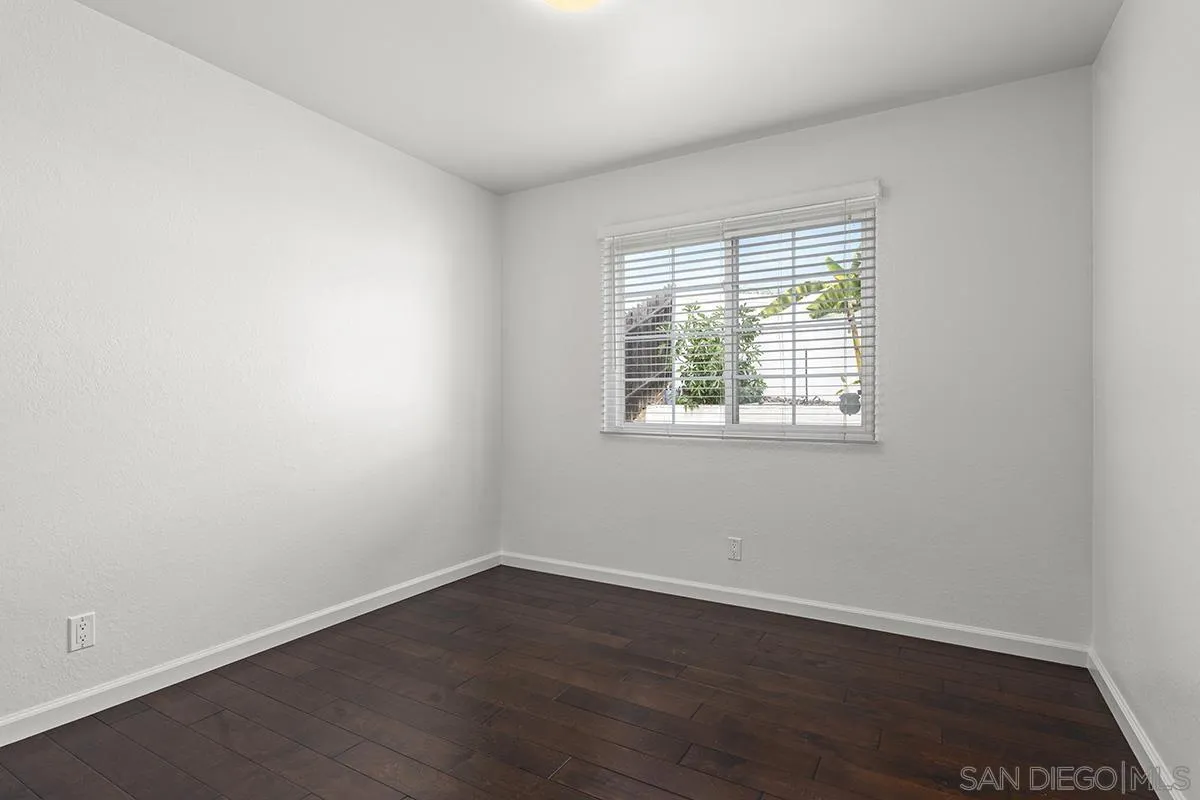 11394 Pegasus Avenue San Diego, CA 92126 - Photo 29 of 46 an empty room with wooden floor and windows