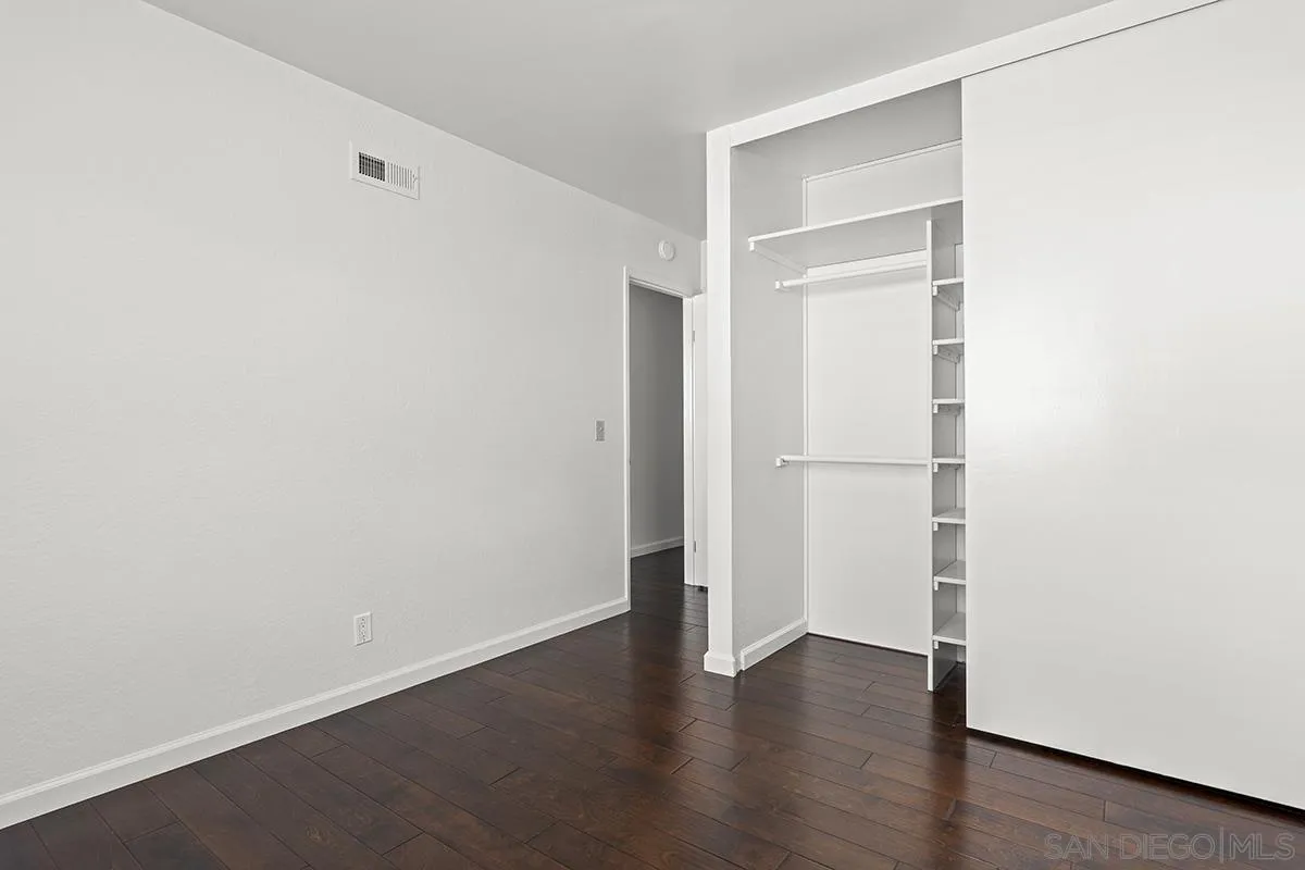 11394 Pegasus Avenue San Diego, CA 92126 - Photo 30 of 46 a view of an empty room with wooden floor