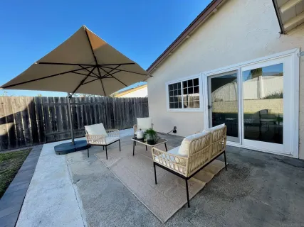 a patio with a patio table and chairs