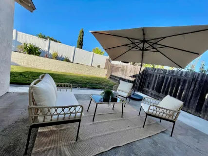 a view of a chairs and table in the patio