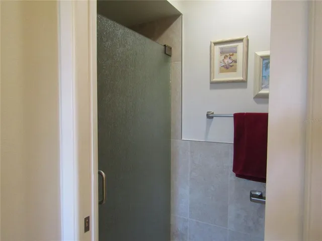 a bathroom with a shower and a mirror