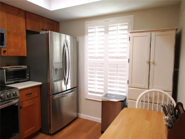 a kitchen with stainless steel appliances a refrigerator sink and cabinets