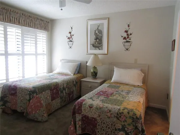 a bedroom with two beds and a window