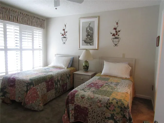 a bedroom with two beds and a window