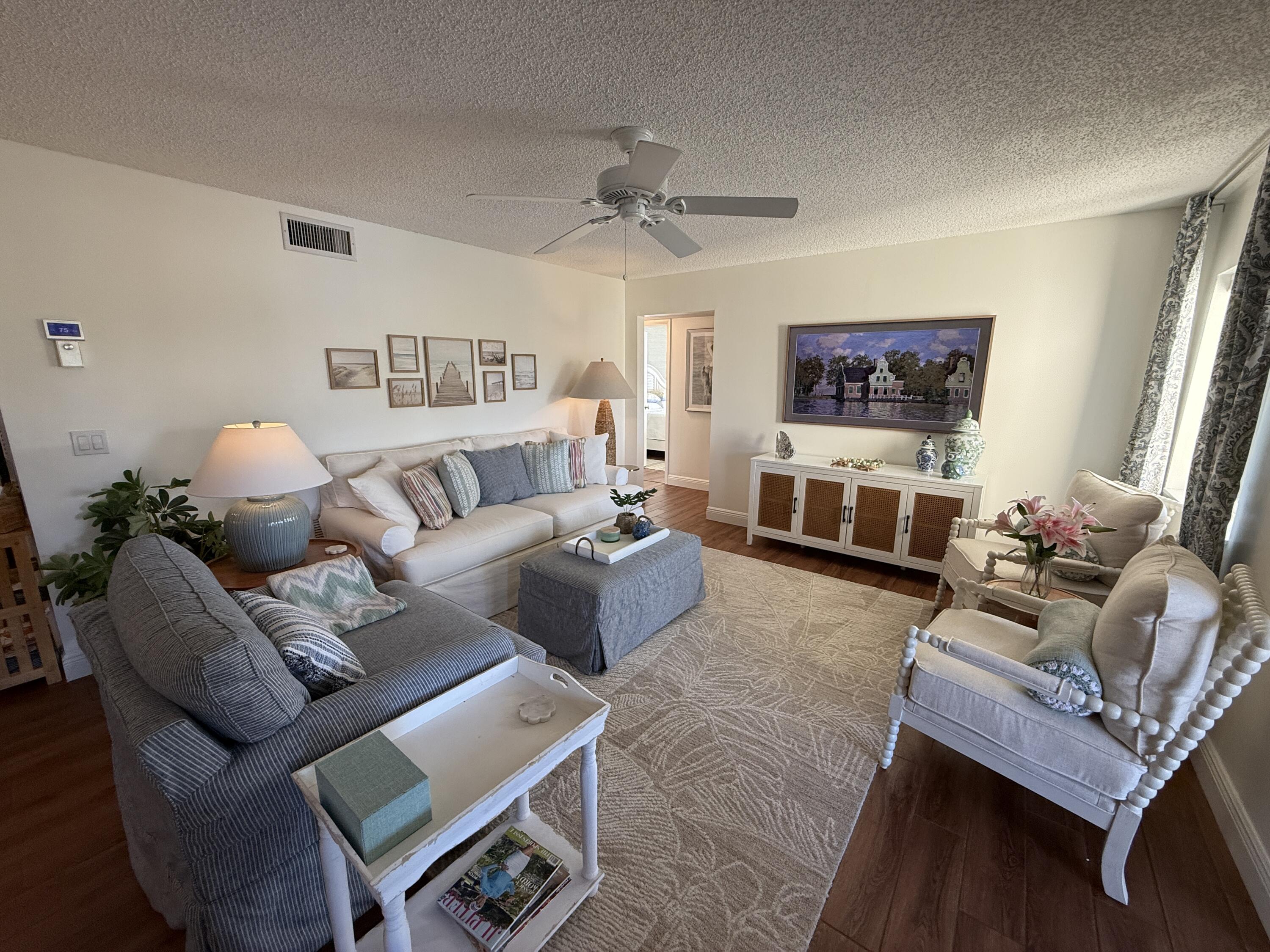 338 Pine Ridge Circle, Unit B2 Greenacres, FL 33463 - Photo 13 of 56 a living room with furniture and a flat screen tv