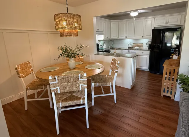 a view of a dining room with furniture wooden floor and chandelier