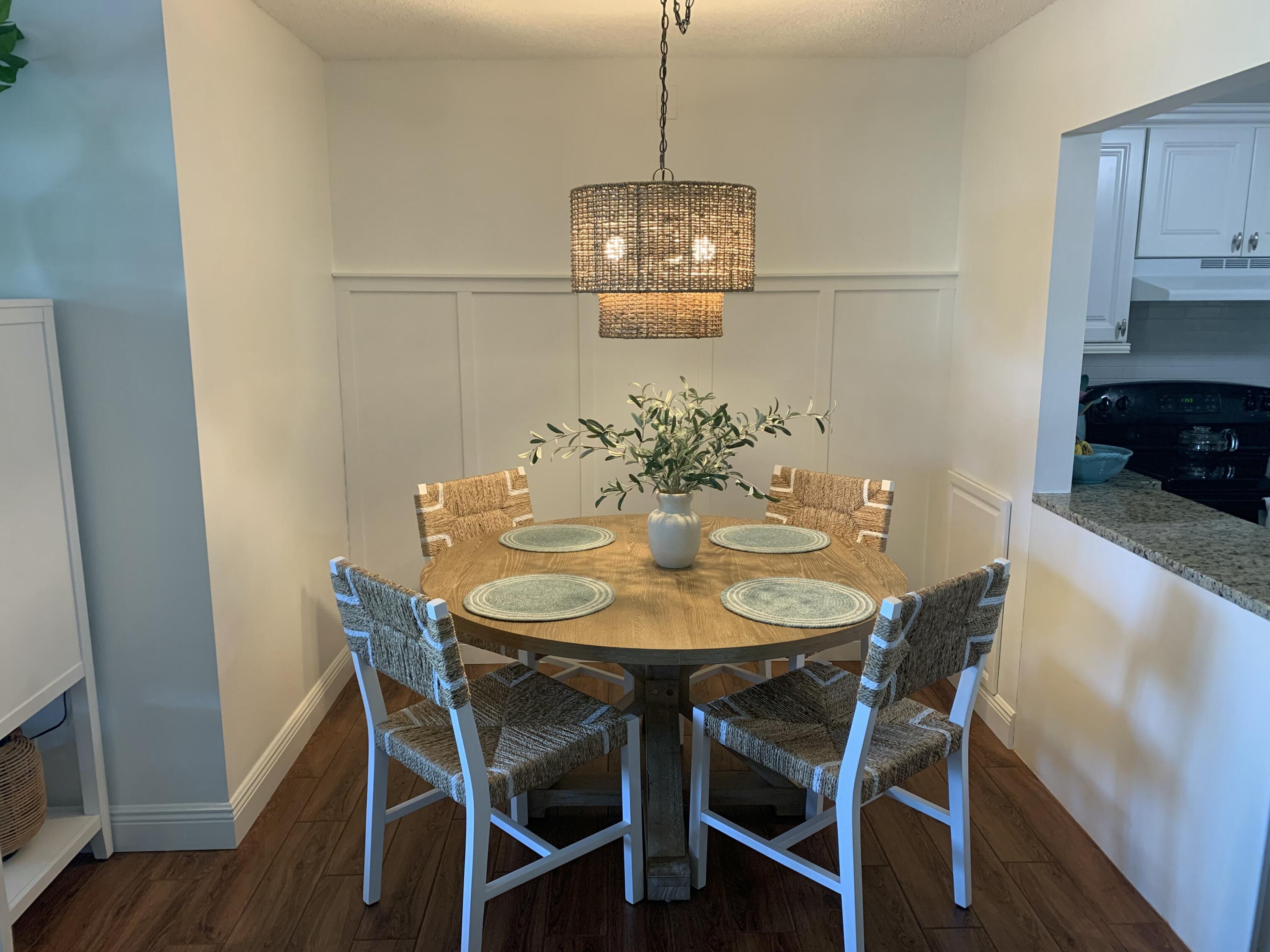 338 Pine Ridge Circle, Unit B2 Greenacres, FL 33463 - Photo 19 of 56 a view of a dining room with furniture and wooden floor