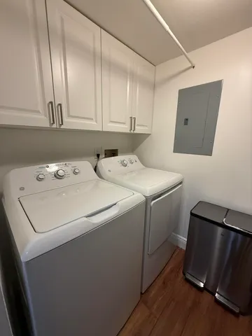 a kitchen with a stove and a wooden floor