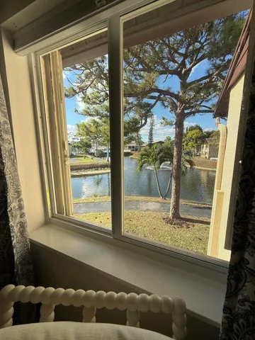 a view of a hallway with wooden floor and closet