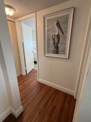 a bedroom with a bed and a mirror on dresser