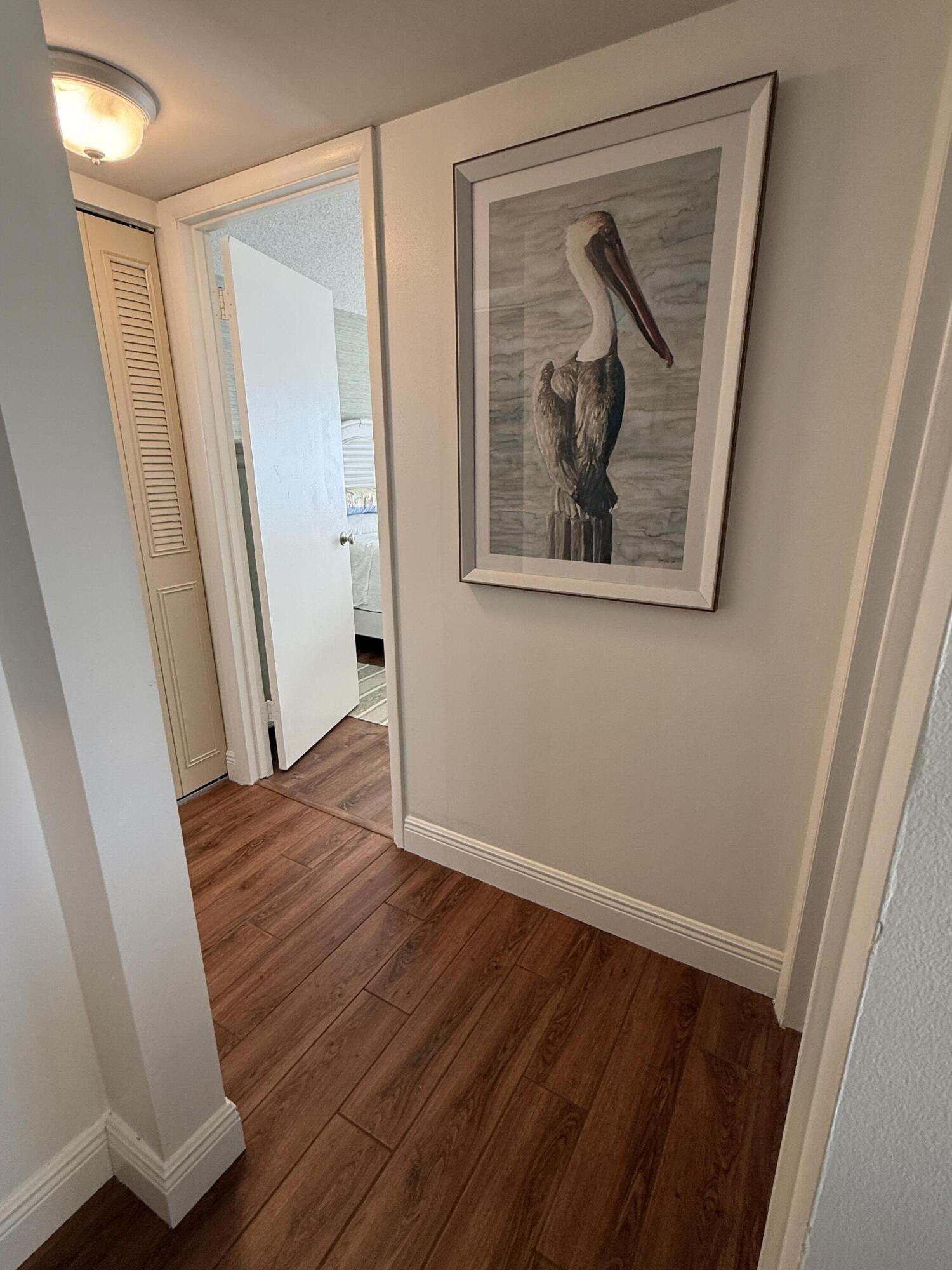 338 Pine Ridge Circle, Unit B2 Greenacres, FL 33463 - Photo 26 of 56 a view of a hallway with wooden floor and closet