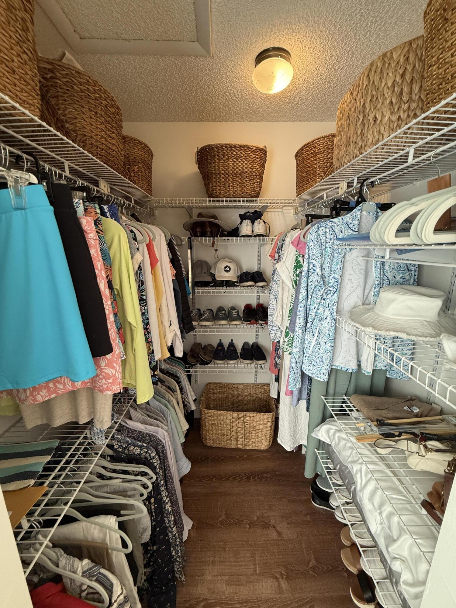 338 Pine Ridge Circle, Unit B2 Greenacres, FL 33463 - Photo 29 of 56 a view of walk in closet with clothes and shoes