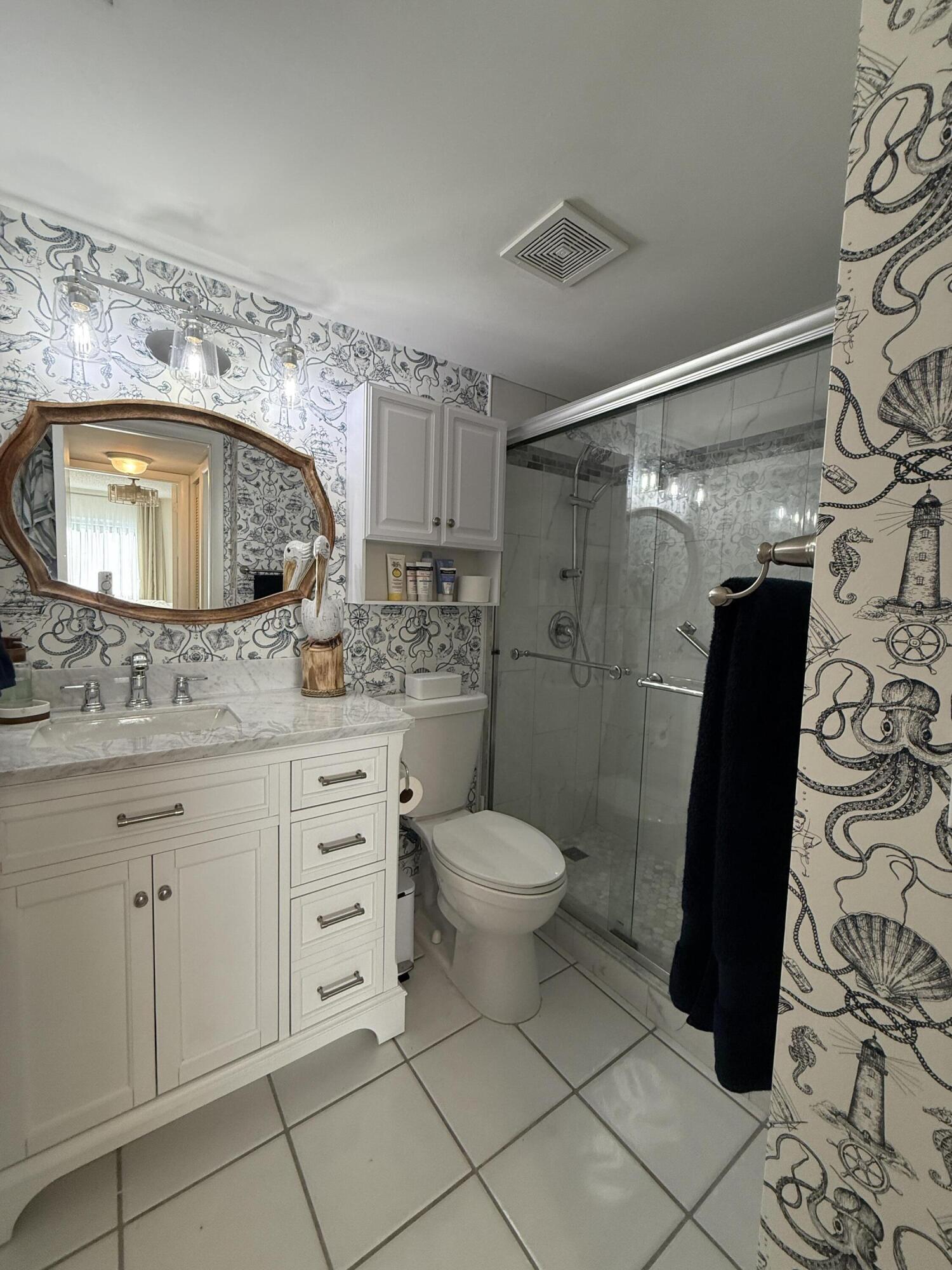 338 Pine Ridge Circle, Unit B2 Greenacres, FL 33463 - Photo 31 of 56 a bathroom with a granite countertop sink toilet and shower