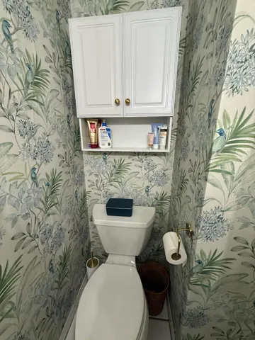 a view of a house with a yard and potted plants