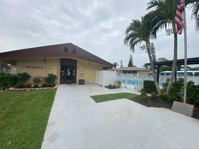 a view of a swimming pool with a yard from a corridor