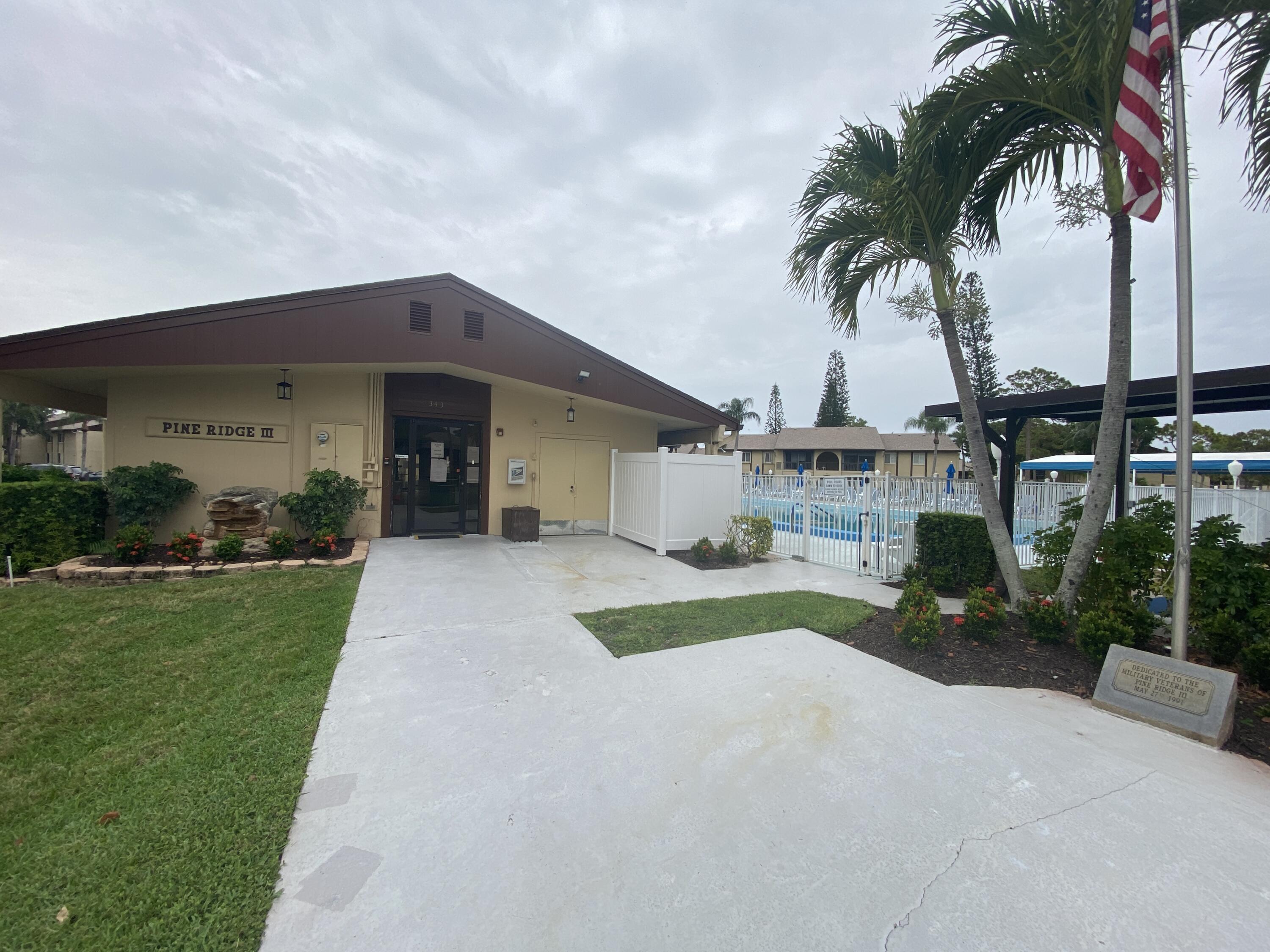 338 Pine Ridge Circle, Unit B2 Greenacres, FL 33463 - Photo 41 of 56 a view of a house with a yard and potted plants