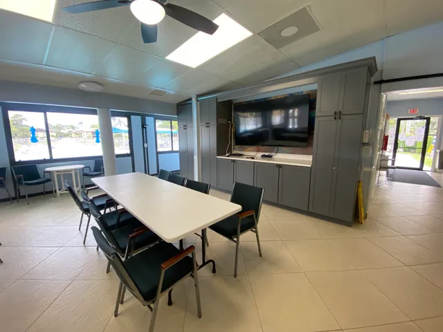 a view of a patio with table and chairs barbeque with wooden floor