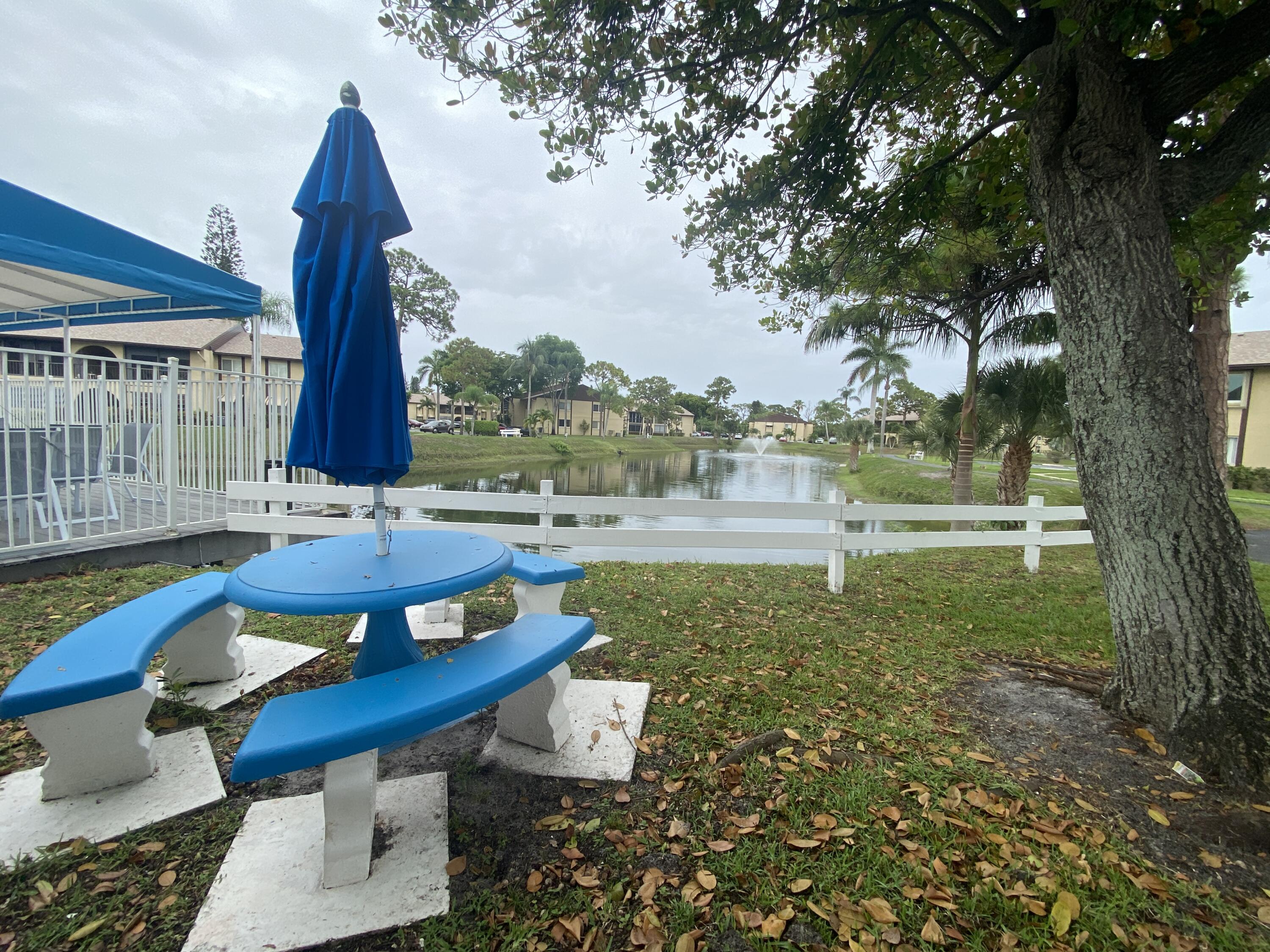 338 Pine Ridge Circle, Unit B2 Greenacres, FL 33463 - Photo 48 of 56 a view of a backyard with sitting area furniture and garden