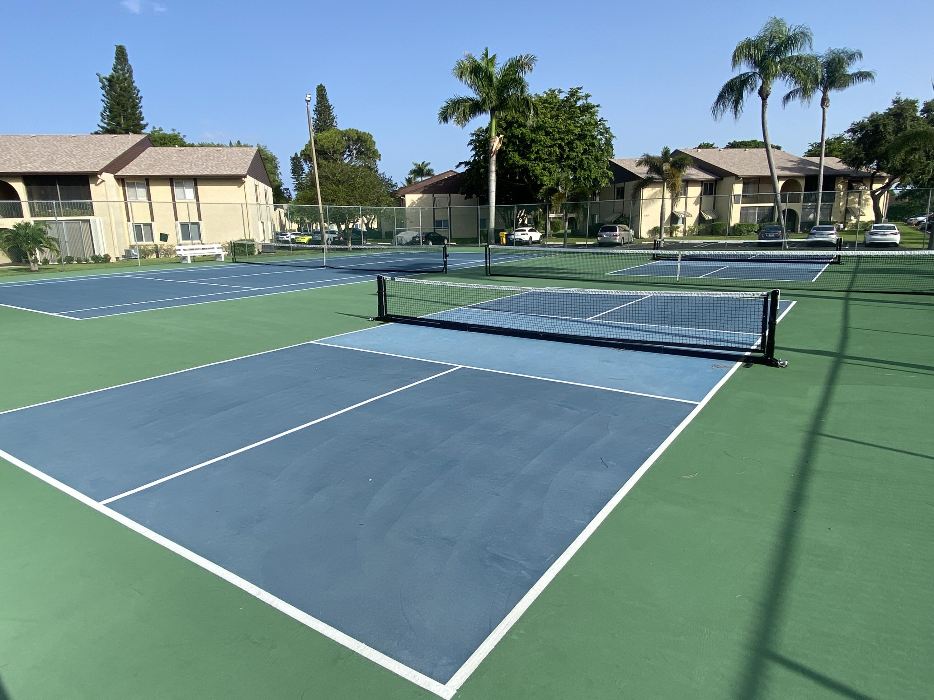 338 Pine Ridge Circle, Unit B2 Greenacres, FL 33463 - Photo 50 of 56 a view of a tennis court