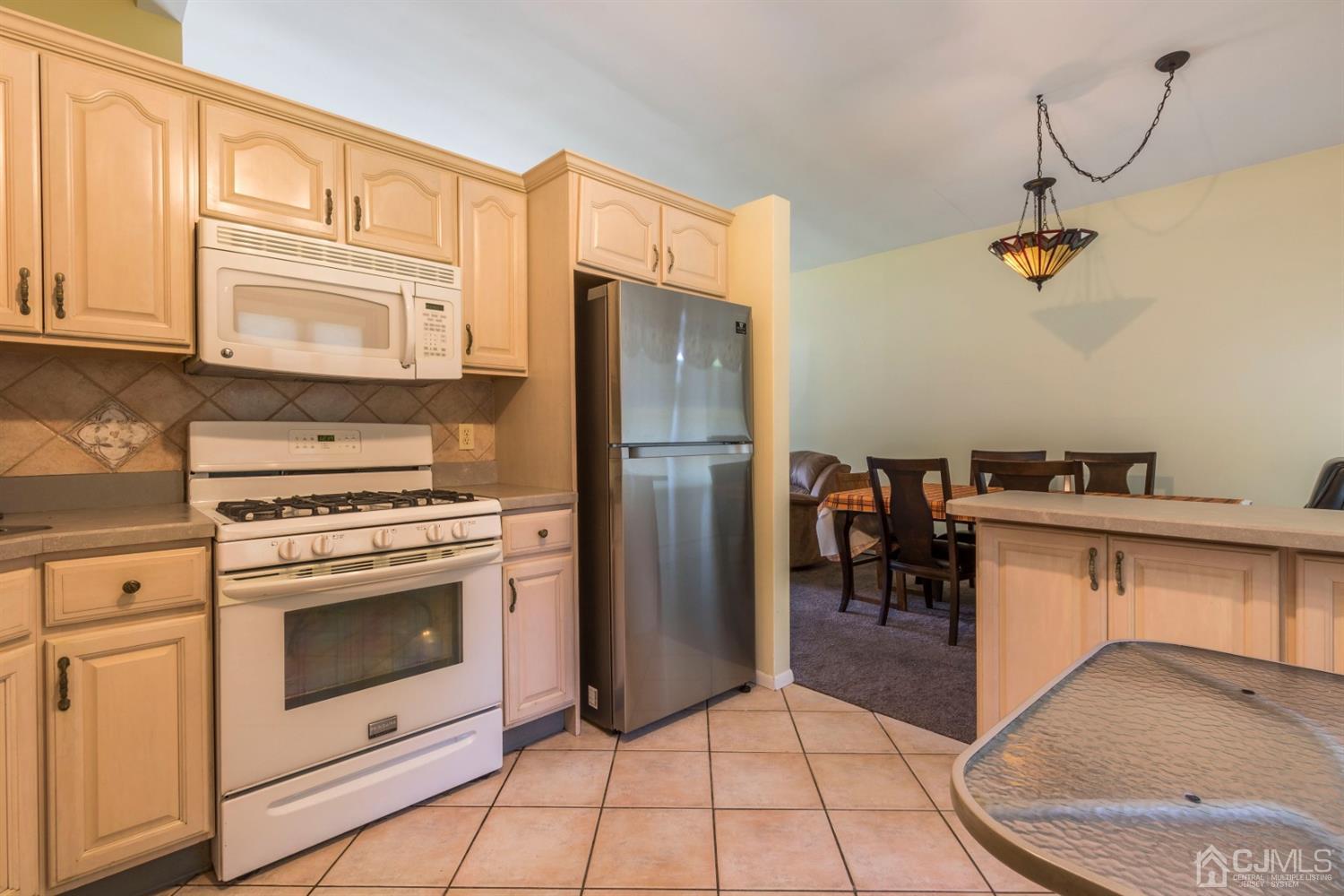 27 Mill Road Edison, NJ 08817 - Photo 12 of 31 a kitchen with stainless steel appliances granite countertop a stove a refrigerator and a cabinets