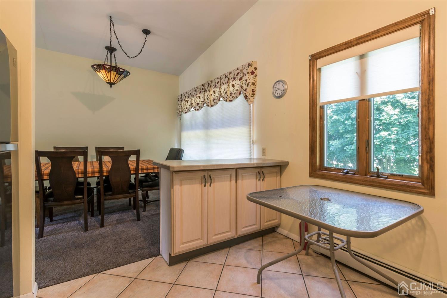 27 Mill Road Edison, NJ 08817 - Photo 13 of 31 a dining room table in a room