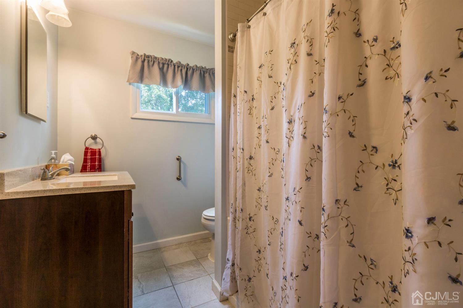 27 Mill Road Edison, NJ 08817 - Photo 18 of 31 a bathroom with a sink and a mirror