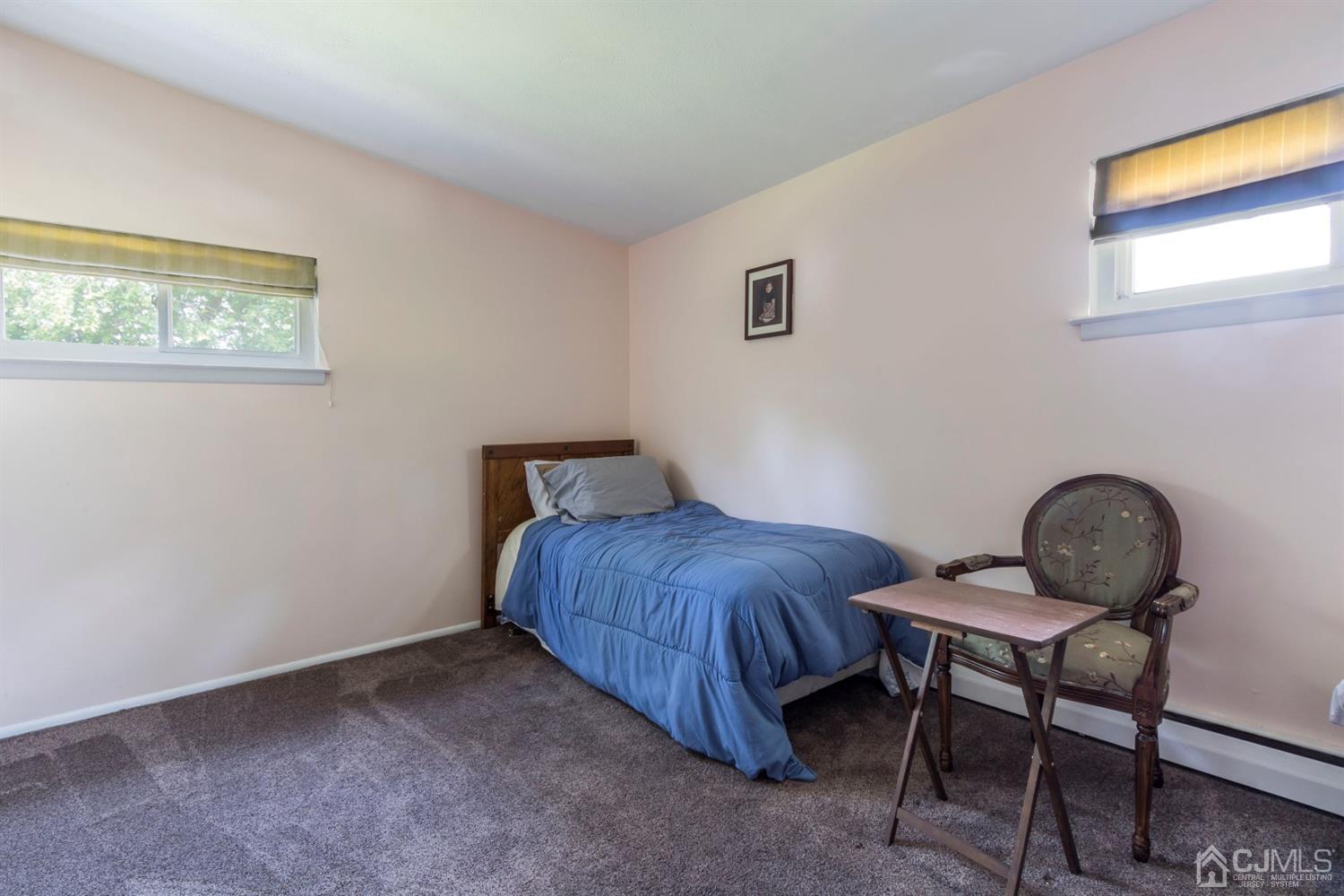 27 Mill Road Edison, NJ 08817 - Photo 19 of 31 a bedroom with a bed and a window