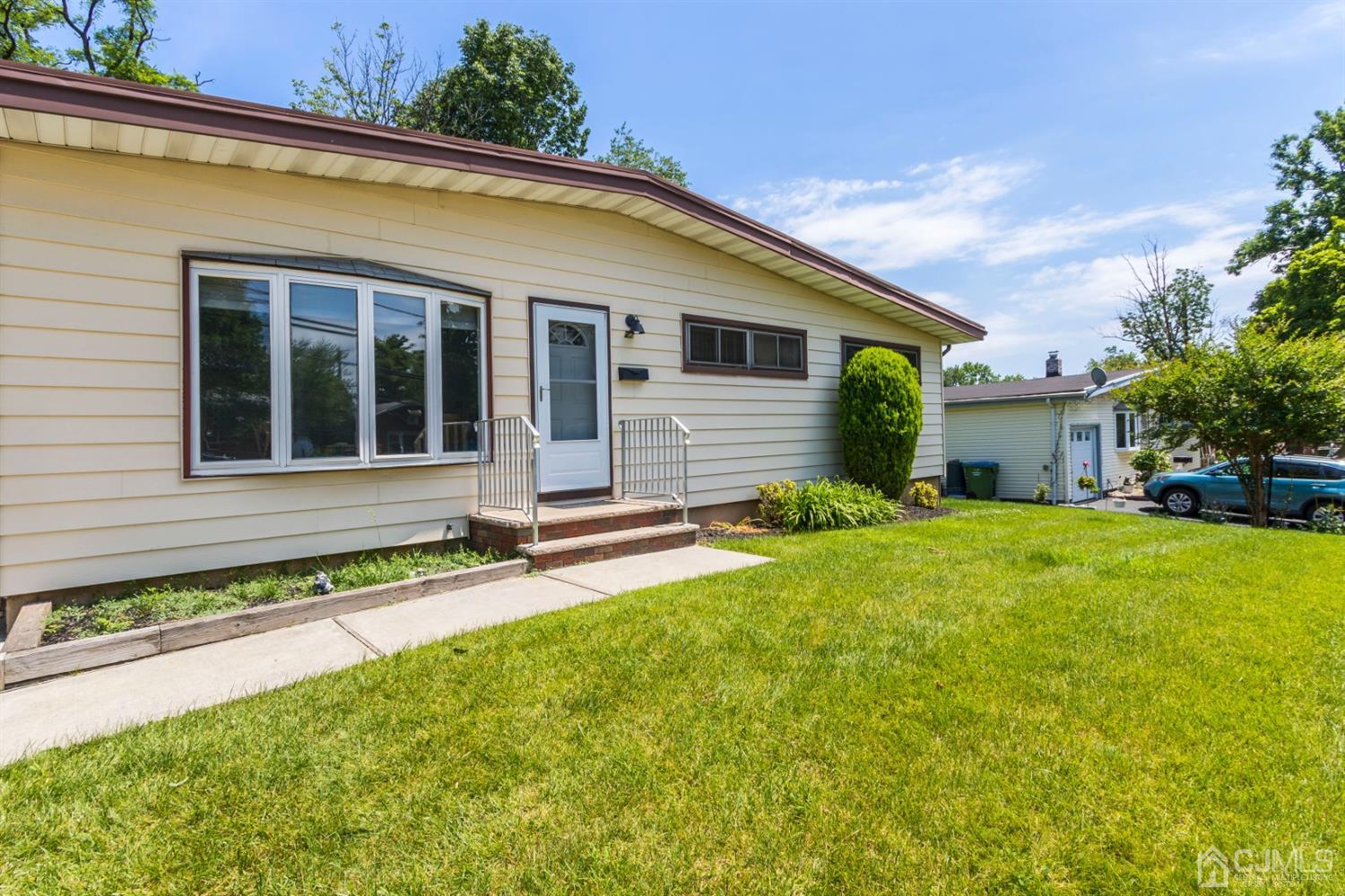 27 Mill Road Edison, NJ 08817 - Photo 3 of 31 front view of a house with a yard